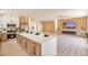 Open-concept space with a kitchen island that flows into the living area with an entertainment center at 2561 Terrytown Ave, Henderson, NV 89052