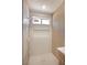 Modern shower with a rainfall shower head, niche, and light wood paneling at 2561 Terrytown Ave, Henderson, NV 89052