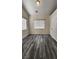 Neutral bedroom featuring gray wood-look flooring, closet, and two windows at 2707 Gardenia Flower Ave, North Las Vegas, NV 89031