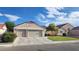 Charming single-story home featuring a well-manicured lawn and a two-car garage at 2707 Gardenia Flower Ave, North Las Vegas, NV 89031