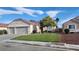 Beautiful single-story home boasts a well-maintained lawn and mature landscaping at 2707 Gardenia Flower Ave, North Las Vegas, NV 89031