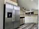 Kitchen featuring stainless steel refrigerator and dishwasher, along with a ceiling fan at 2707 Gardenia Flower Ave, North Las Vegas, NV 89031