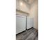 Laundry room with gray wood-look flooring and modern washer and dryer at 2707 Gardenia Flower Ave, North Las Vegas, NV 89031