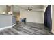 Open concept living room featuring a fireplace, ceiling fan, and gray wood-look flooring at 2707 Gardenia Flower Ave, North Las Vegas, NV 89031