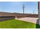 Backyard featuring artificial turf, privacy walls, brick pavers, and gated access at 288 Whitney Crest St, Henderson, NV 89015