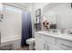 Bathroom featuring modern vanity, tub and shower combination, and decorative accents at 288 Whitney Crest St, Henderson, NV 89015