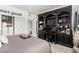 Bedroom featuring an integrated home office area with dark wood shelving and desk, and closet at 288 Whitney Crest St, Henderson, NV 89015