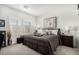 Comfortable bedroom featuring a plush bed, neutral decor, and plenty of natural light from two windows at 288 Whitney Crest St, Henderson, NV 89015