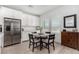 Bright dining area featuring a modern table, stainless steel appliances, and neutral decor at 288 Whitney Crest St, Henderson, NV 89015