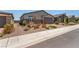Street view of a modern home exterior featuring low maintenance desert landscaping and neutral color palette at 288 Whitney Crest St, Henderson, NV 89015