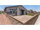 Inviting single-story home with a stone wall, paved driveway, and small patch of artificial turf at 288 Whitney Crest St, Henderson, NV 89015