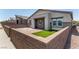 Charming single-story home with a stone wall, paved driveway, and small patch of artificial turf at 288 Whitney Crest St, Henderson, NV 89015