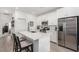Bright kitchen featuring stainless appliances, white cabinetry, and island with bar stool seating at 288 Whitney Crest St, Henderson, NV 89015