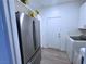 Well-lit laundry area adjacent to the kitchen, equipped with modern appliances and storage at 288 Whitney Crest St, Henderson, NV 89015