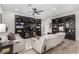 Spacious living room with built-in shelving units, comfortable seating, and hardwood-style floors at 288 Whitney Crest St, Henderson, NV 89015