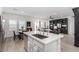 Bright, open-concept living space featuring modern island, stainless steel appliances and adjacent dining area at 288 Whitney Crest St, Henderson, NV 89015