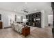 Bright living room showcasing a large entertainment center, plush seating, and wood-look floors at 288 Whitney Crest St, Henderson, NV 89015