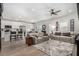 Open-concept living room featuring modern furniture, neutral tones, and lots of natural light at 288 Whitney Crest St, Henderson, NV 89015