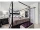 Bedroom showcases a four-poster bed and sliding barn door to ensuite bathroom and walk-in closet at 288 Whitney Crest St, Henderson, NV 89015