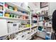 Well-organized walk-in pantry with white shelving and storage containers at 288 Whitney Crest St, Henderson, NV 89015
