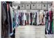 Organized walk-in closet with hanging clothes, shelves, and drawers for storage at 288 Whitney Crest St, Henderson, NV 89015