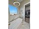 Modern bathroom features a freestanding tub with marble surround and contemporary light fixture at 2891 S Rainbow Ave, Pahrump, NV 89048