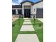 Close-up view of the front entrance featuring a secured wrought iron gate and walkway at 2891 S Rainbow Ave, Pahrump, NV 89048
