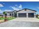 Single-story home with an artifical lawn, desert landscaping, and a two-car garage at 2891 S Rainbow Ave, Pahrump, NV 89048