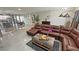 View of the living room with a comfortable brown sectional, decorative fireplace, and an open layout at 2891 S Rainbow Ave, Pahrump, NV 89048