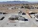 Aerial view of a single-story home with a large lot, detached garage, and ample parking space, set against a mountain backdrop at 3580 Prairie Ave, Pahrump, NV 89048