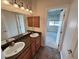 Bright bathroom features double sinks with granite countertops and cabinet storage at 3580 Prairie Ave, Pahrump, NV 89048