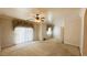 Primary bedroom featuring a ceiling fan, carpet flooring, and a sliding glass door at 3580 Prairie Ave, Pahrump, NV 89048