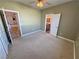 Bedroom boasts neutral carpet and paint, ceiling fan, and convenient en suite bathroom at 3580 Prairie Ave, Pahrump, NV 89048