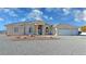 Attractive single story home featuring a three car garage and desert landscaping at 3580 Prairie Ave, Pahrump, NV 89048