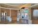 Stunning foyer features decorative columns and a chandelier, showcasing sophisticated design at 3580 Prairie Ave, Pahrump, NV 89048
