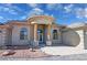 Elegant home entrance featuring a circular portico with columns and a decorative glass door at 3580 Prairie Ave, Pahrump, NV 89048