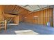 Spacious garage interior featuring exposed wood framing, concrete flooring, and ample workspace at 3580 Prairie Ave, Pahrump, NV 89048