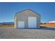 Detached two-car garage with large doors and ample space for vehicle storage and work area at 3580 Prairie Ave, Pahrump, NV 89048