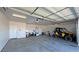 Spacious garage with room for vehicle and storage featuring an assortment of equipment and vehicles at 3580 Prairie Ave, Pahrump, NV 89048