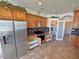 Stylish kitchen features stainless appliances, granite countertops, tile floors, and ample cabinet space at 3580 Prairie Ave, Pahrump, NV 89048