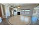 Bright living room features a fireplace, tile floors, and large windows with scenic views at 3580 Prairie Ave, Pahrump, NV 89048