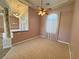 Spacious living room with chandelier, large window and neutral carpet at 3580 Prairie Ave, Pahrump, NV 89048