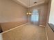 Spacious living room with hanging lights, window and neutral carpet at 3580 Prairie Ave, Pahrump, NV 89048