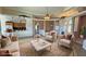 Comfortable living room with neutral colors, plush seating, and seamless transition to the kitchen at 3580 Prairie Ave, Pahrump, NV 89048