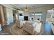 Bright and airy living room with large windows and cozy seating, complemented by a tiled floor at 3580 Prairie Ave, Pahrump, NV 89048