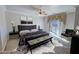 Stylish main bedroom featuring a plush bed, modern decor, and direct access to the backyard area at 3580 Prairie Ave, Pahrump, NV 89048