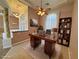 Welcoming home office featuring a classic wooden desk, shelving, and natural light, ideal for productivity at 3580 Prairie Ave, Pahrump, NV 89048