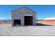 Two-story outbuilding features two garage doors, offering ample storage and workspace at 3580 Prairie Ave, Pahrump, NV 89048