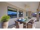 Inviting outdoor patio with a ceiling fan and a dining table creating a relaxing space at 3580 Prairie Ave, Pahrump, NV 89048