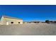 Exterior shot showing a detached garage on a large lot, with another home visible in the background at 3580 Prairie Ave, Pahrump, NV 89048